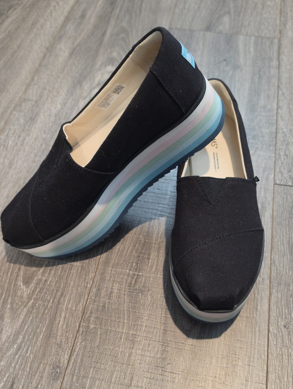 Toms Black Platform Slip-On Shoes with Pastel Stripe Sole